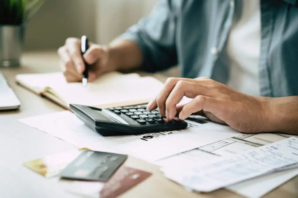 Closeup of hands using a calculator while financial planning