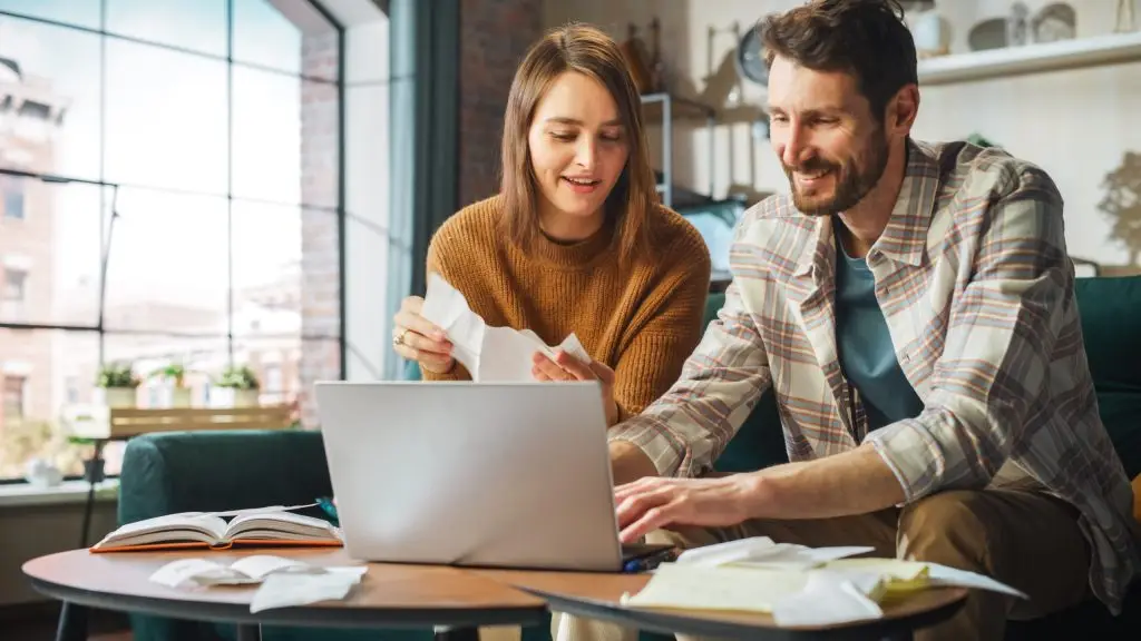 Couple looking at financial information on their laptop