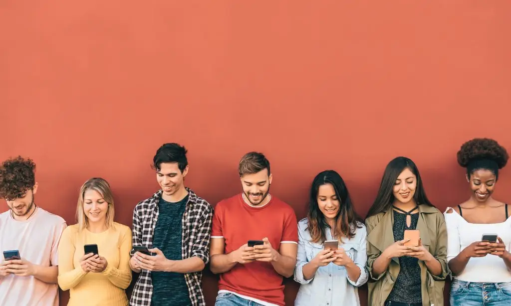 Line of Gen Z people looking at their cellphones