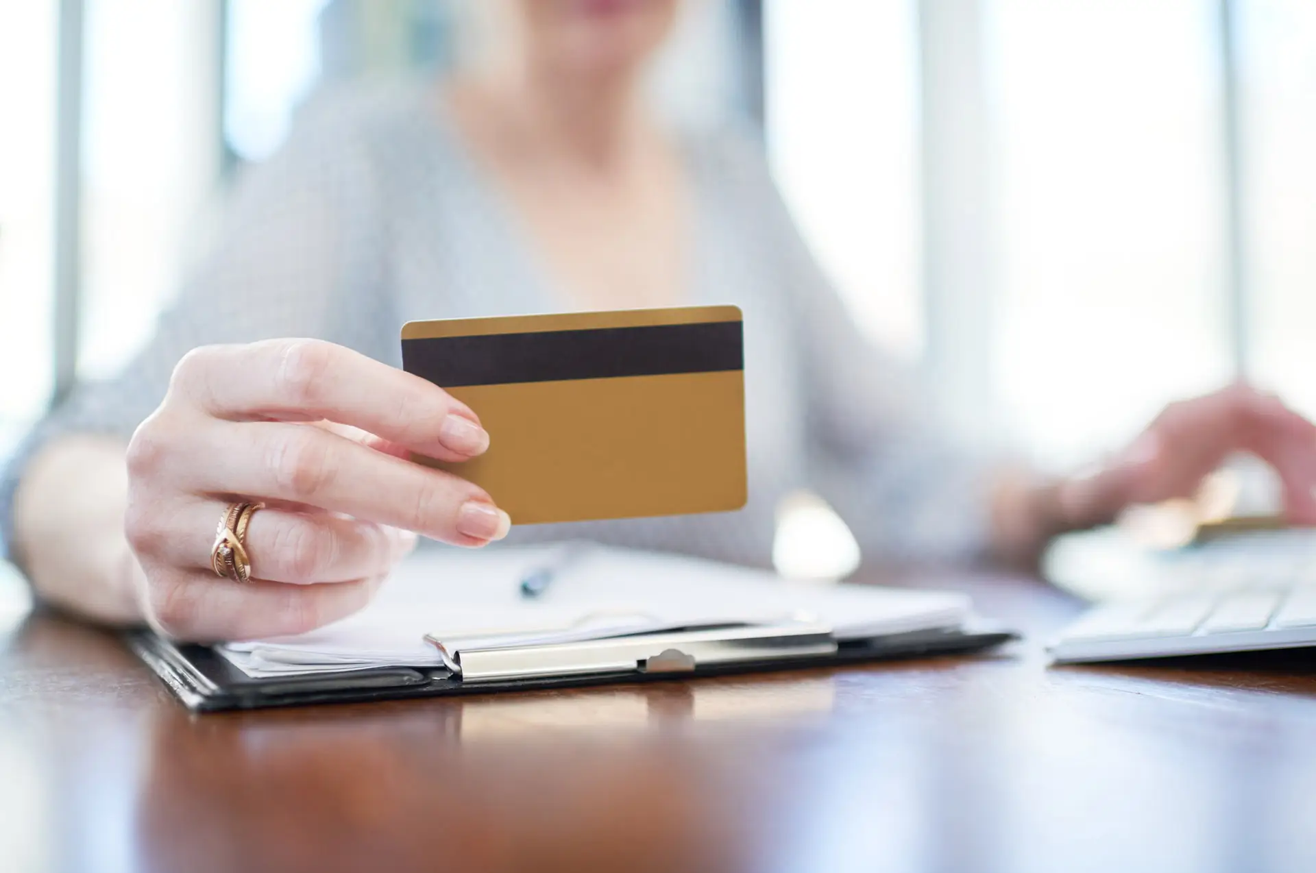Closeup of person holding a debit card
