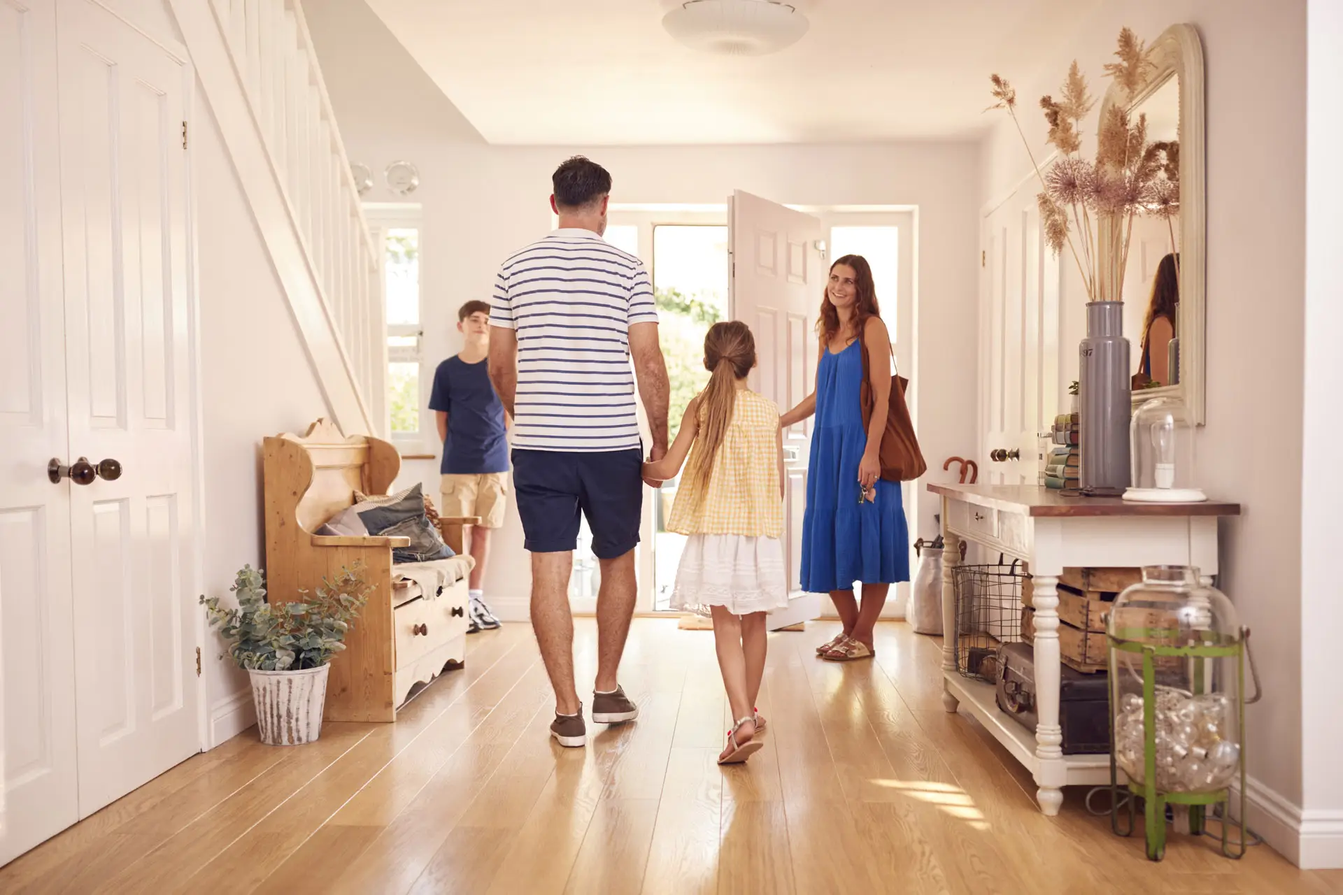 Family leaving their house through their front entryway