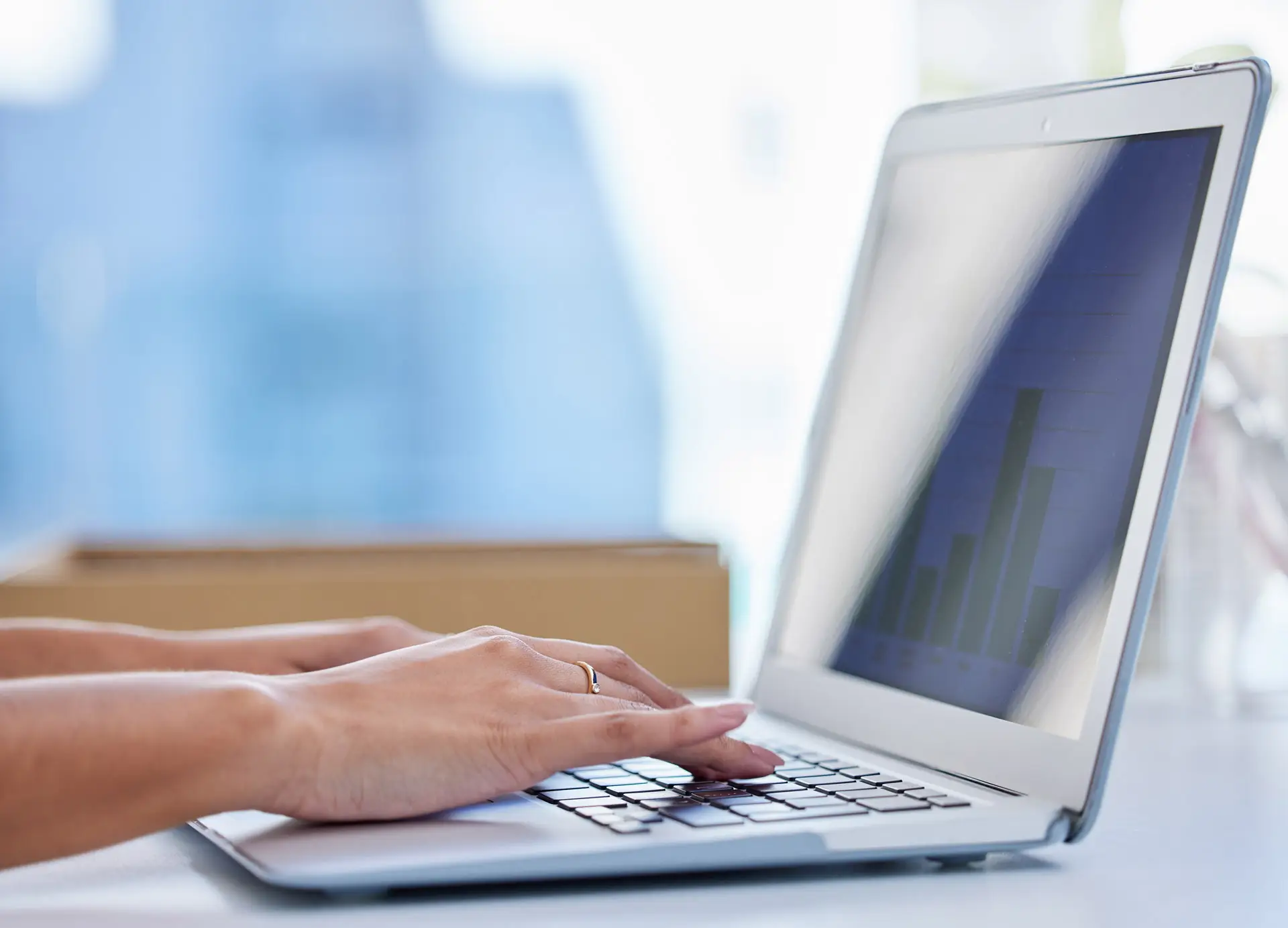 Closeup of hands using a laptop