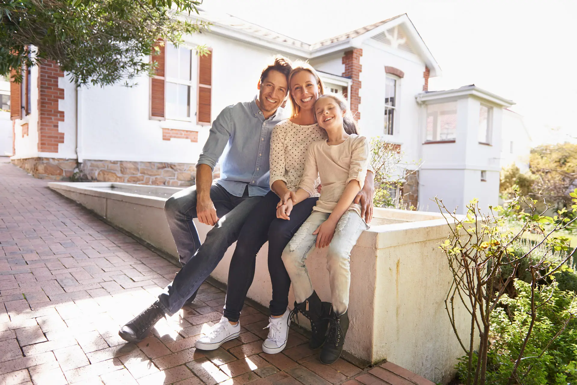Family sitting outside of a home