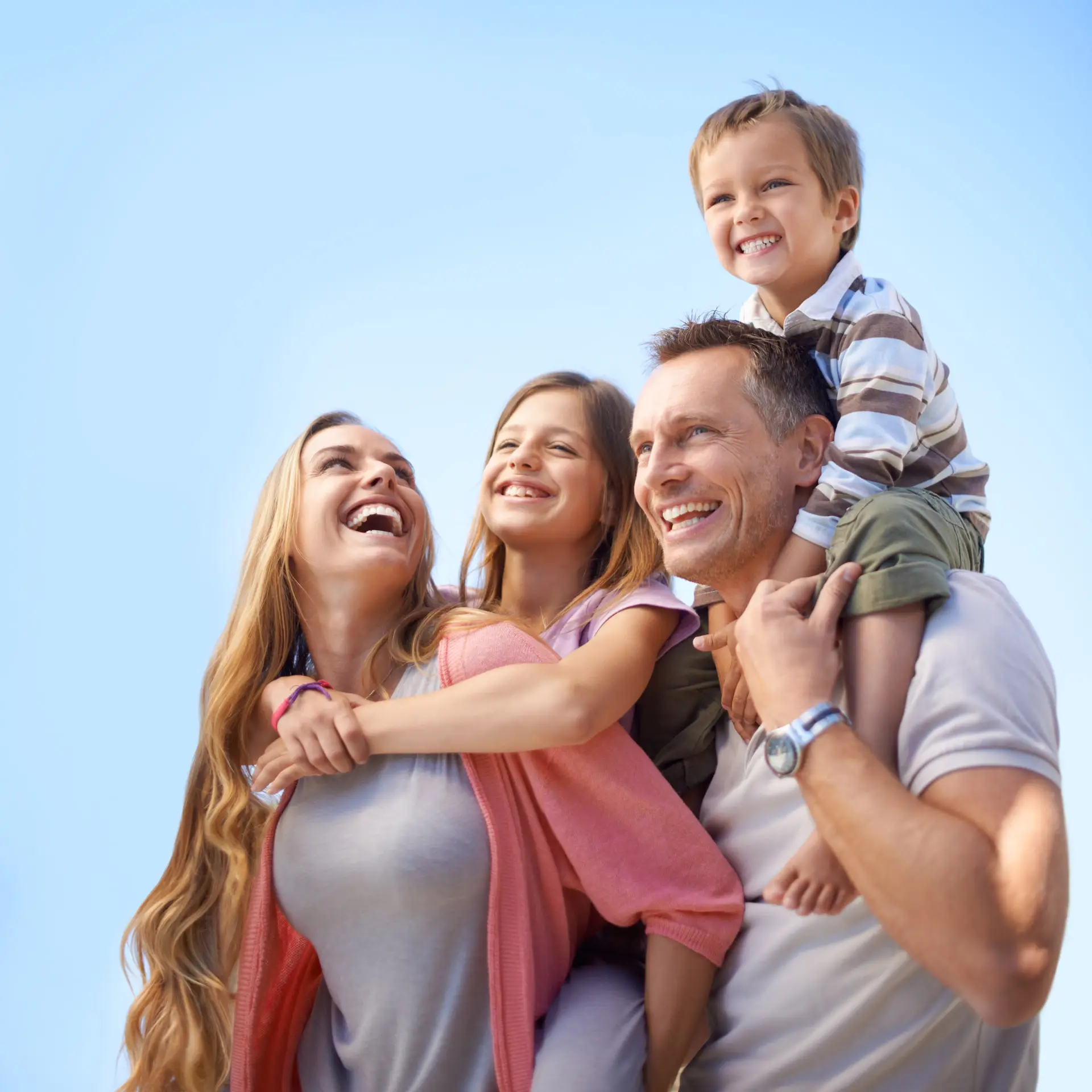 Parents holding their two children and smiling at them
