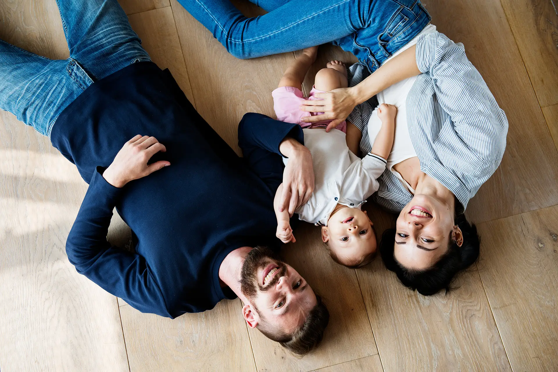 Family laying on the floor, looking at the ceiling