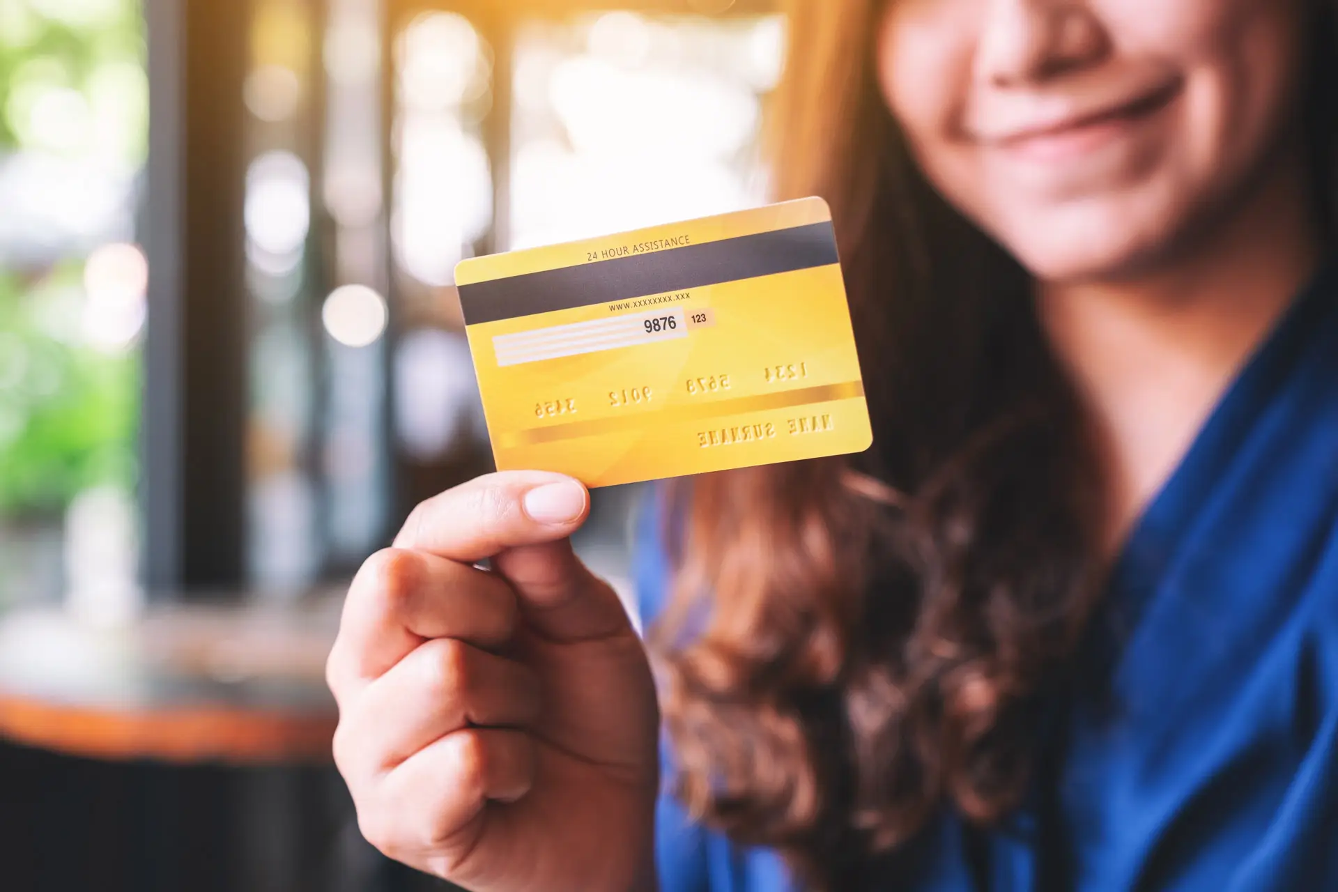 Woman holding a debit card