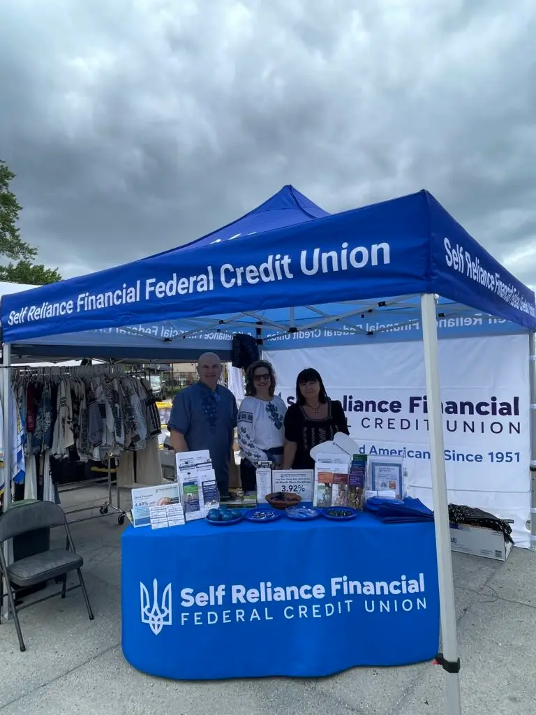 SRFFCU team in an SRFFCU branded tent at a community event